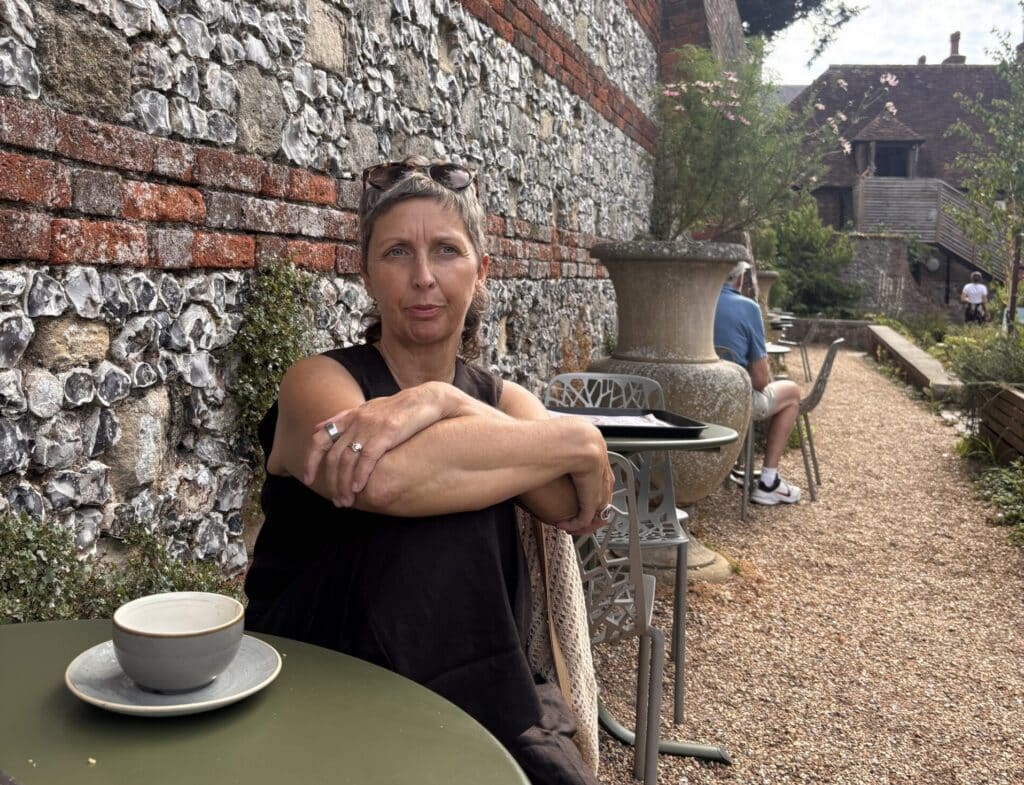 Sharon reflecting with coffee